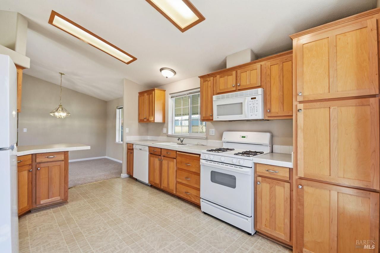 121 Coronado Circle Santa Rosa, CA 95409 - Photo 8 of 32 a kitchen with stainless steel appliances granite countertop a stove a sink and a refrigerator