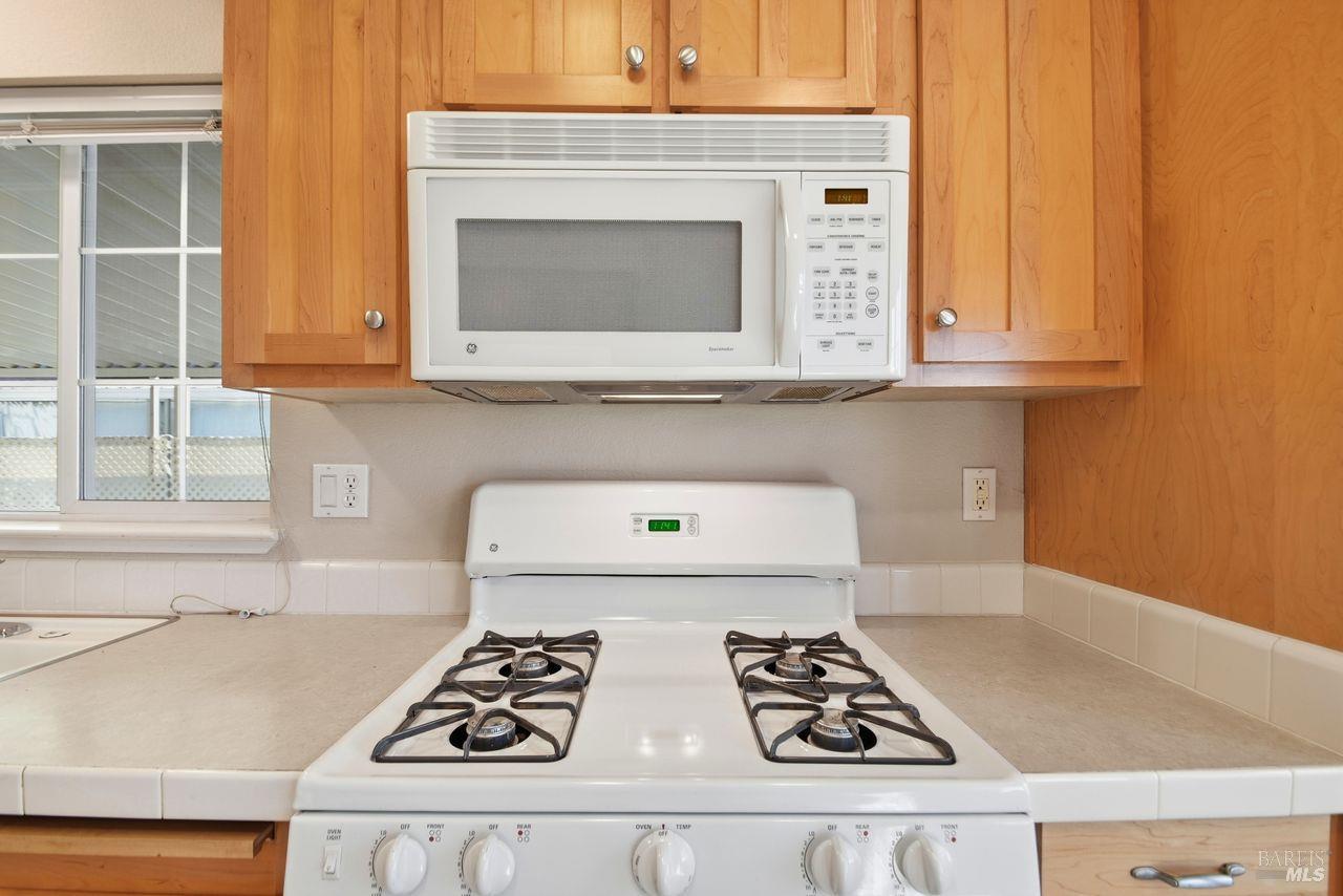 121 Coronado Circle Santa Rosa, CA 95409 - Photo 9 of 32 a kitchen with cabinets and white appliances