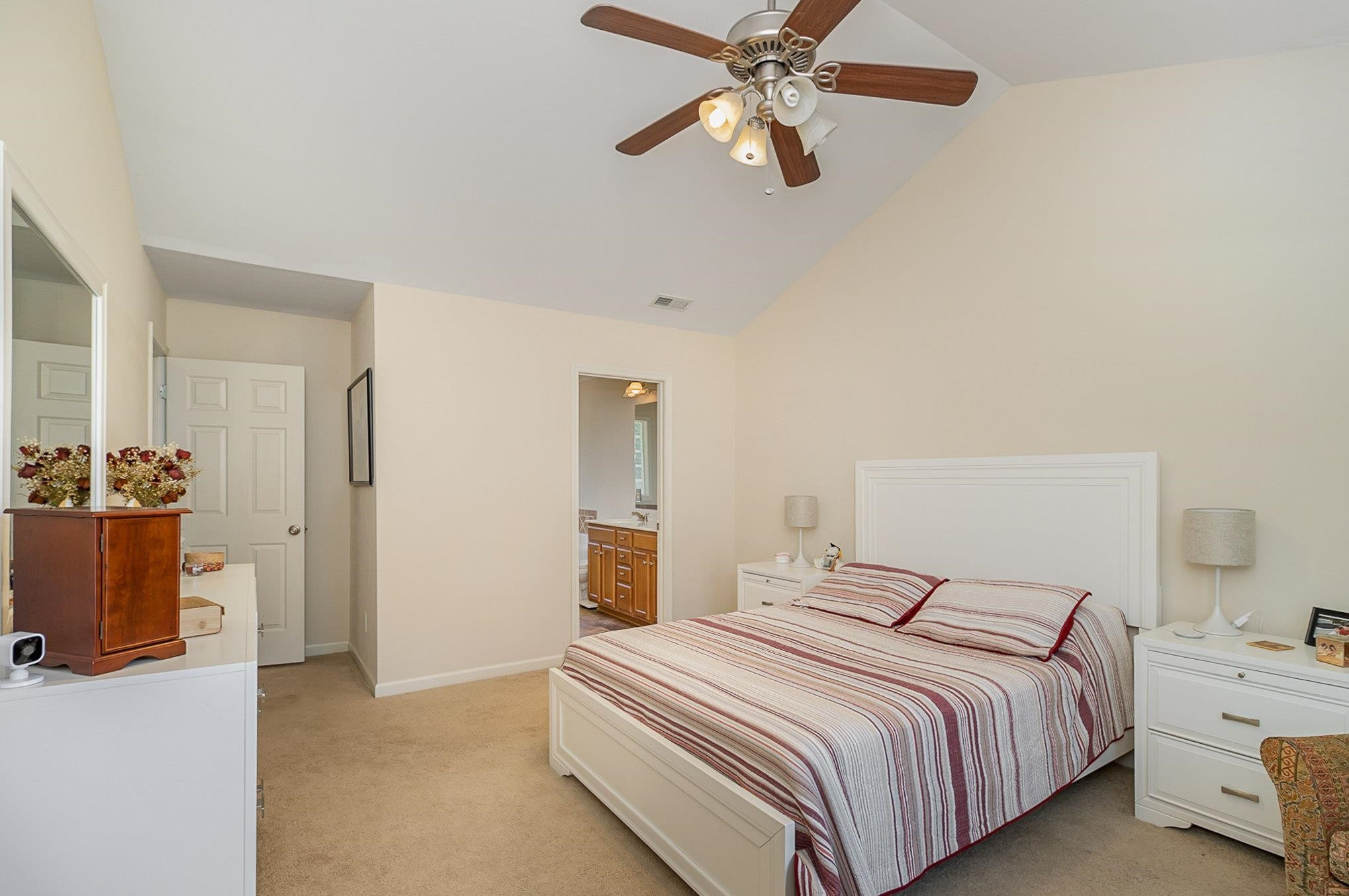 226 Keller Drive Clayton, NC 27520 - Photo 15 of 30 a bedroom with a bed and a chandelier
