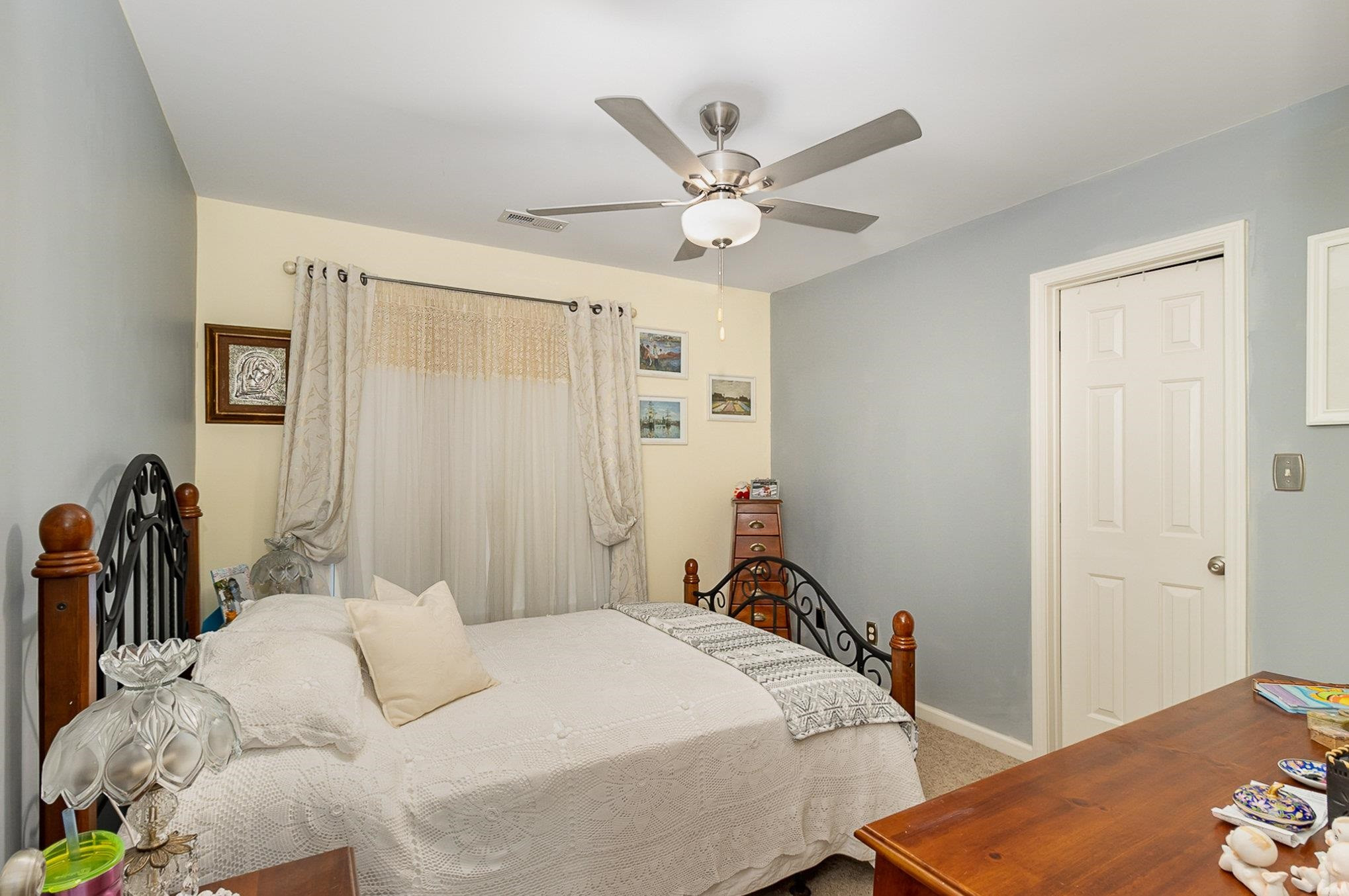 226 Keller Drive Clayton, NC 27520 - Photo 18 of 30 a bedroom with a bed and a chandelier