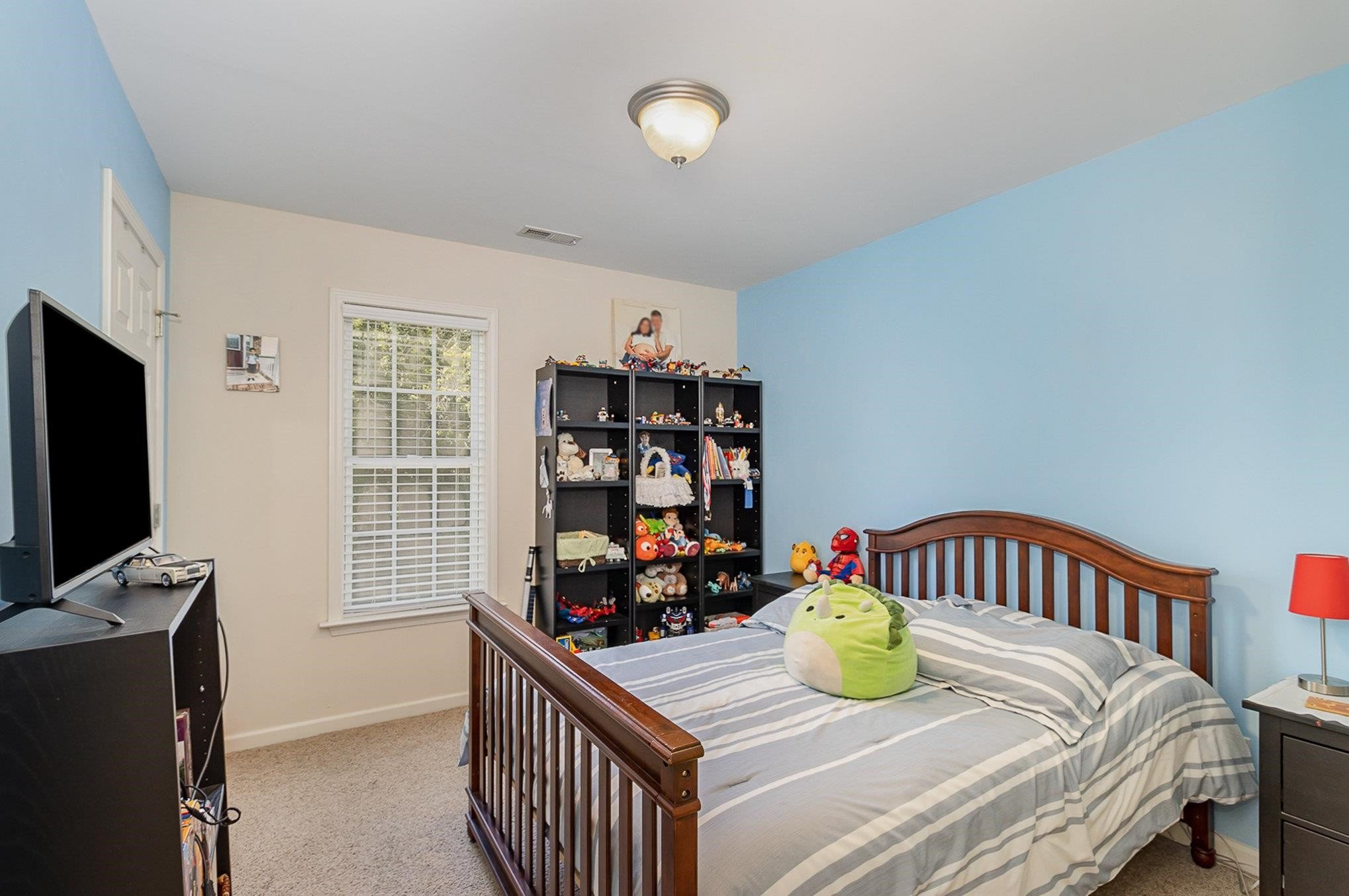 226 Keller Drive Clayton, NC 27520 - Photo 20 of 30 a bedroom with a bed and a tv