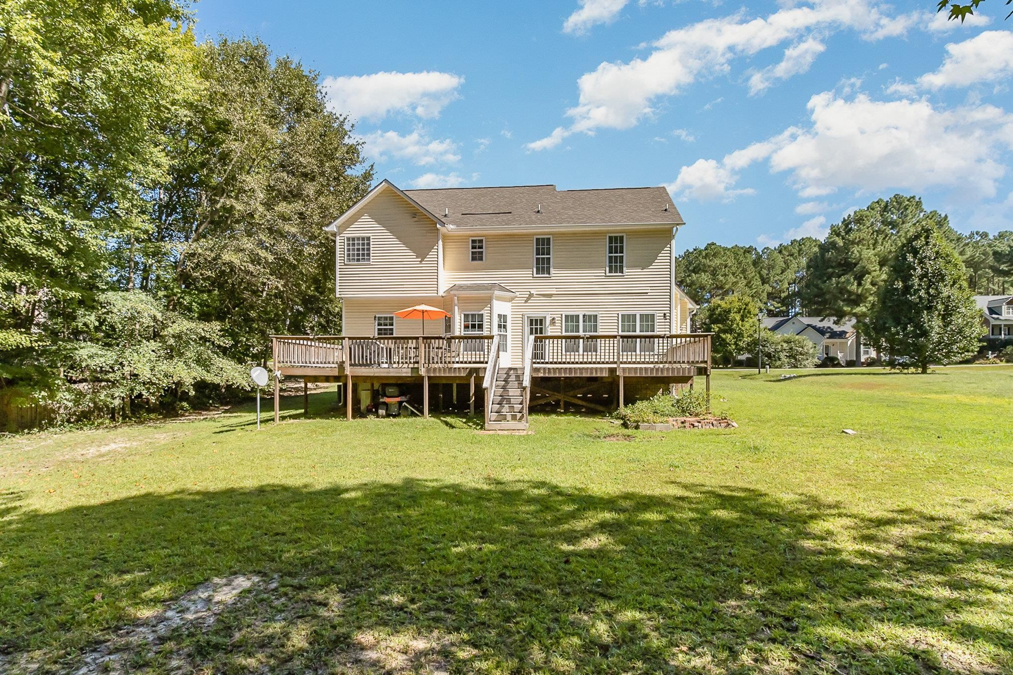 226 Keller Drive Clayton, NC 27520 - Photo 27 of 30 a view of a house with a big yard and large trees