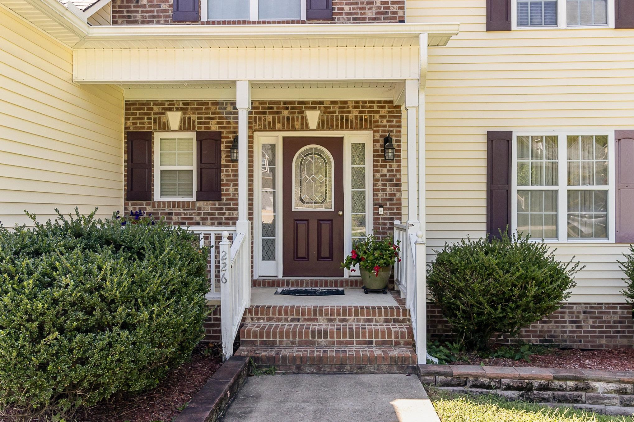 226 Keller Drive Clayton, NC 27520 - Photo 5 of 30 a front view of a house with a garden