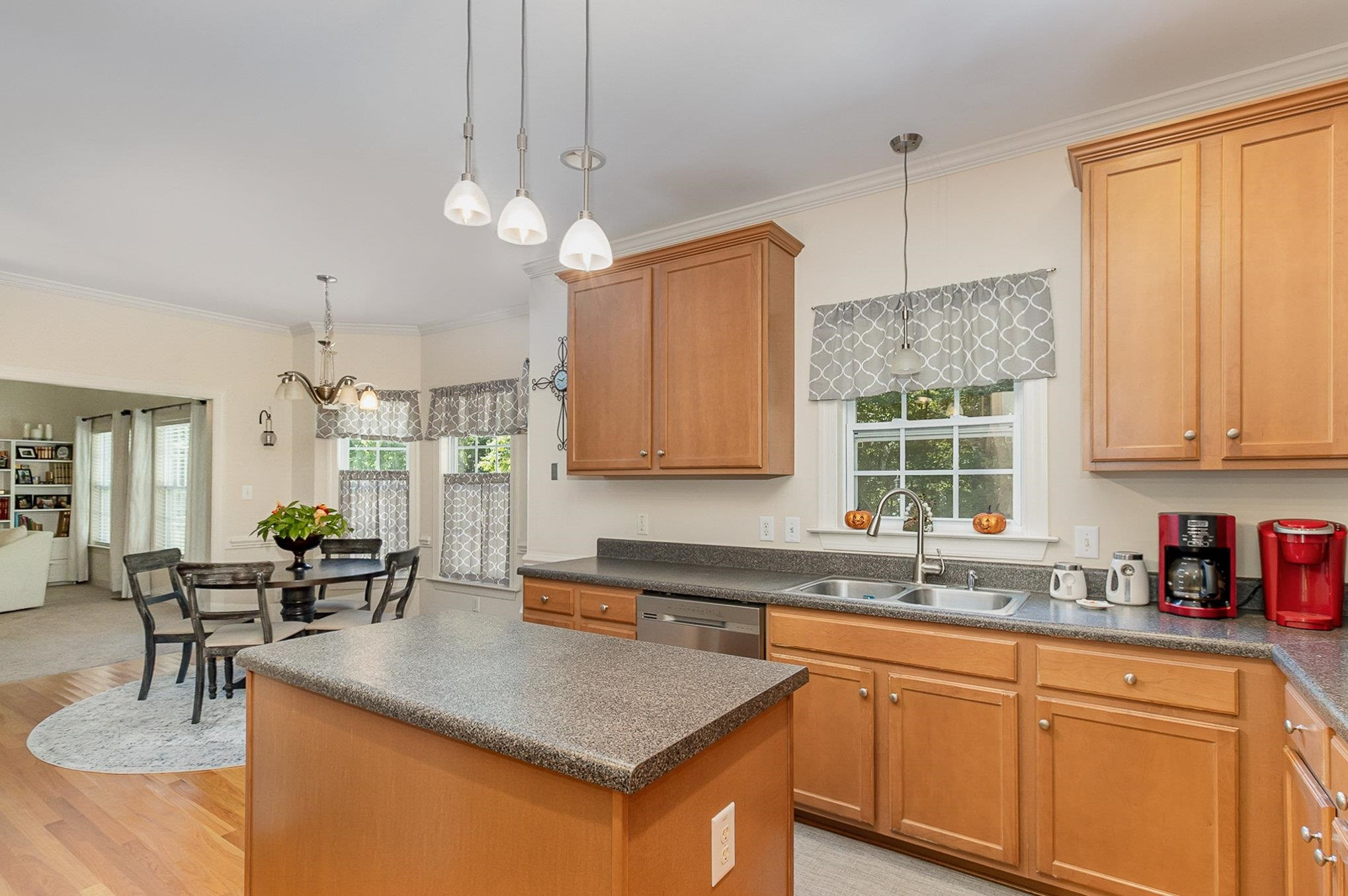 226 Keller Drive Clayton, NC 27520 - Photo 9 of 30 a kitchen with cabinets a center island and windows