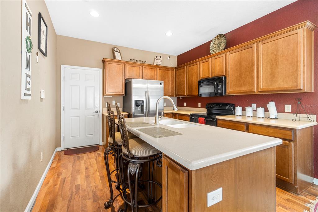 4199 Southwest 46th Court Ocala, FL 34474 - Photo 15 of 50 a kitchen with a stove a sink and a refrigerator