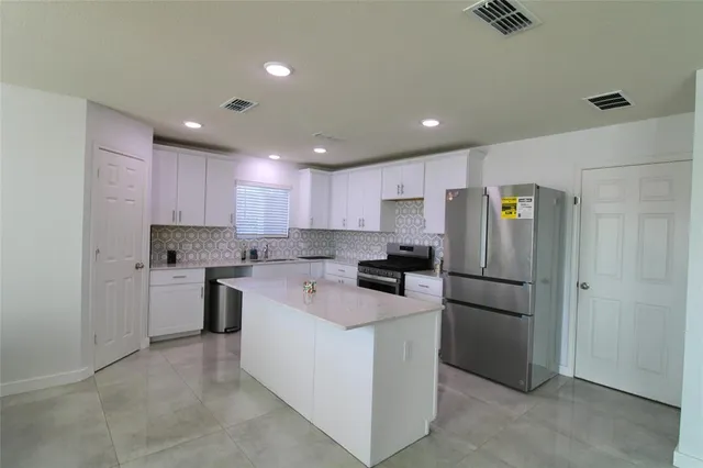a kitchen with a refrigerator a sink and dishwasher