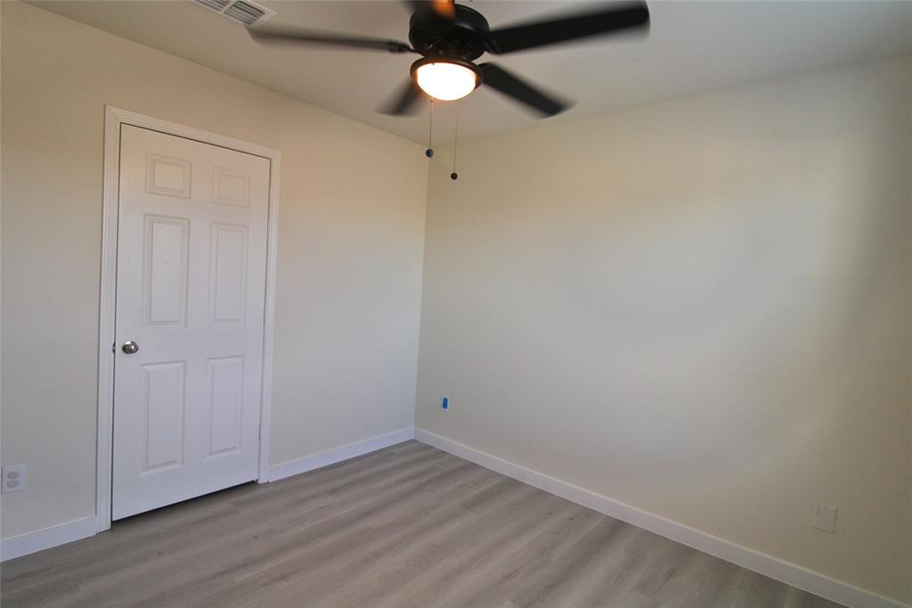 949 Shire Avenue Haslet, TX 76052 - Photo 8 of 22 Unfurnished bedroom featuring light wood-type flooring and ceiling fan