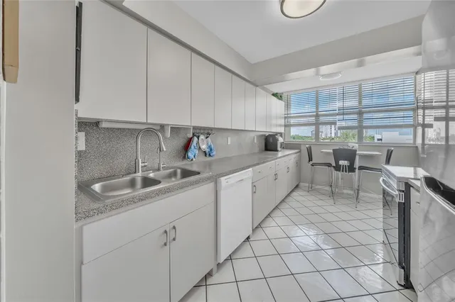 a kitchen with a sink cabinets and window