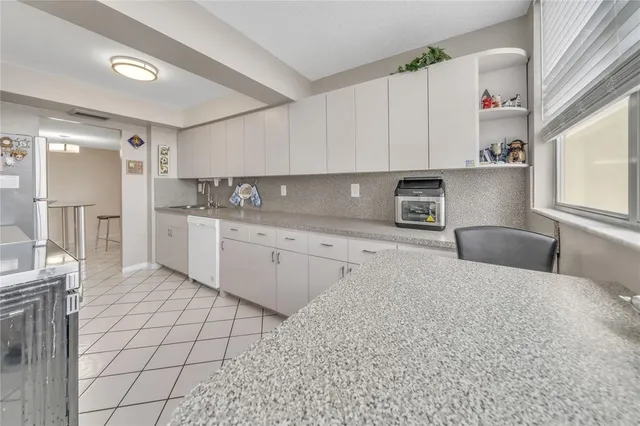 a kitchen with stainless steel appliances granite countertop a sink and cabinets
