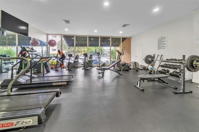 a dining room with furniture and a flat screen tv