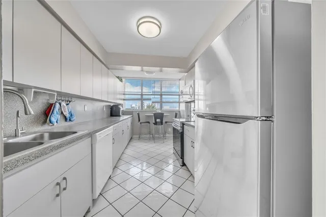 a kitchen with a sink and refrigerator