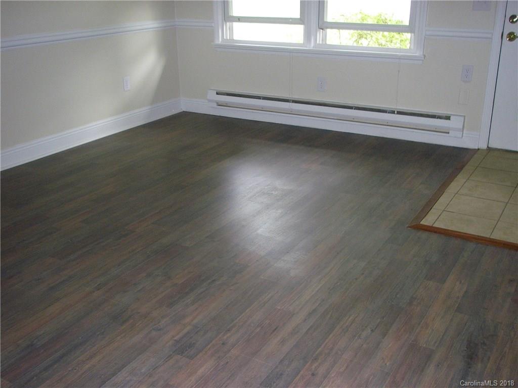 71 Pebblebrook Street Clyde, NC 28721 - Photo 14 of 17 an empty room with wooden floor and windows