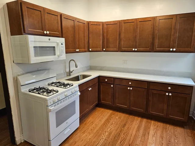 a kitchen with wooden cabinets and a stove top oven
