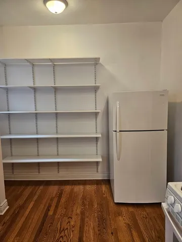 a view of a room with wooden floor and a window