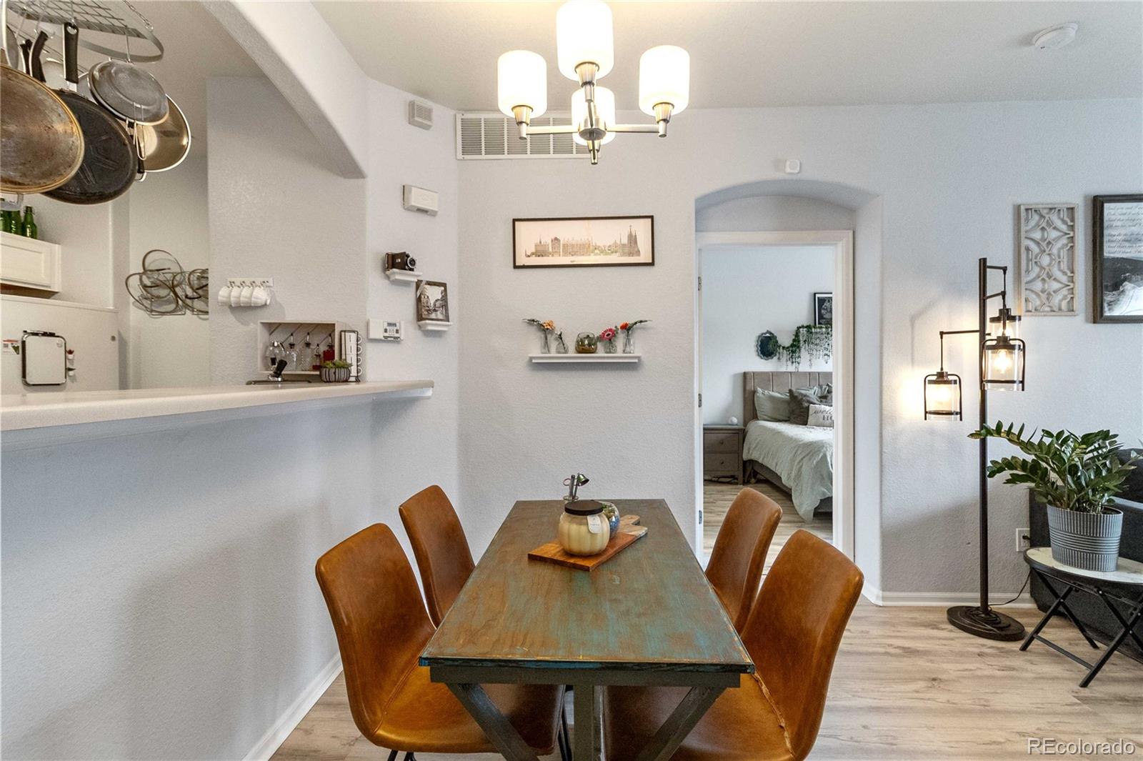 5255 Memphis Street, Unit 702 Denver, CO 80239 - Photo 5 of 30 a view of a dining room with furniture and wooden floor