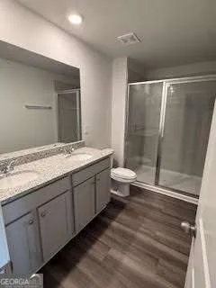 a bathroom with a granite countertop sink toilet and shower