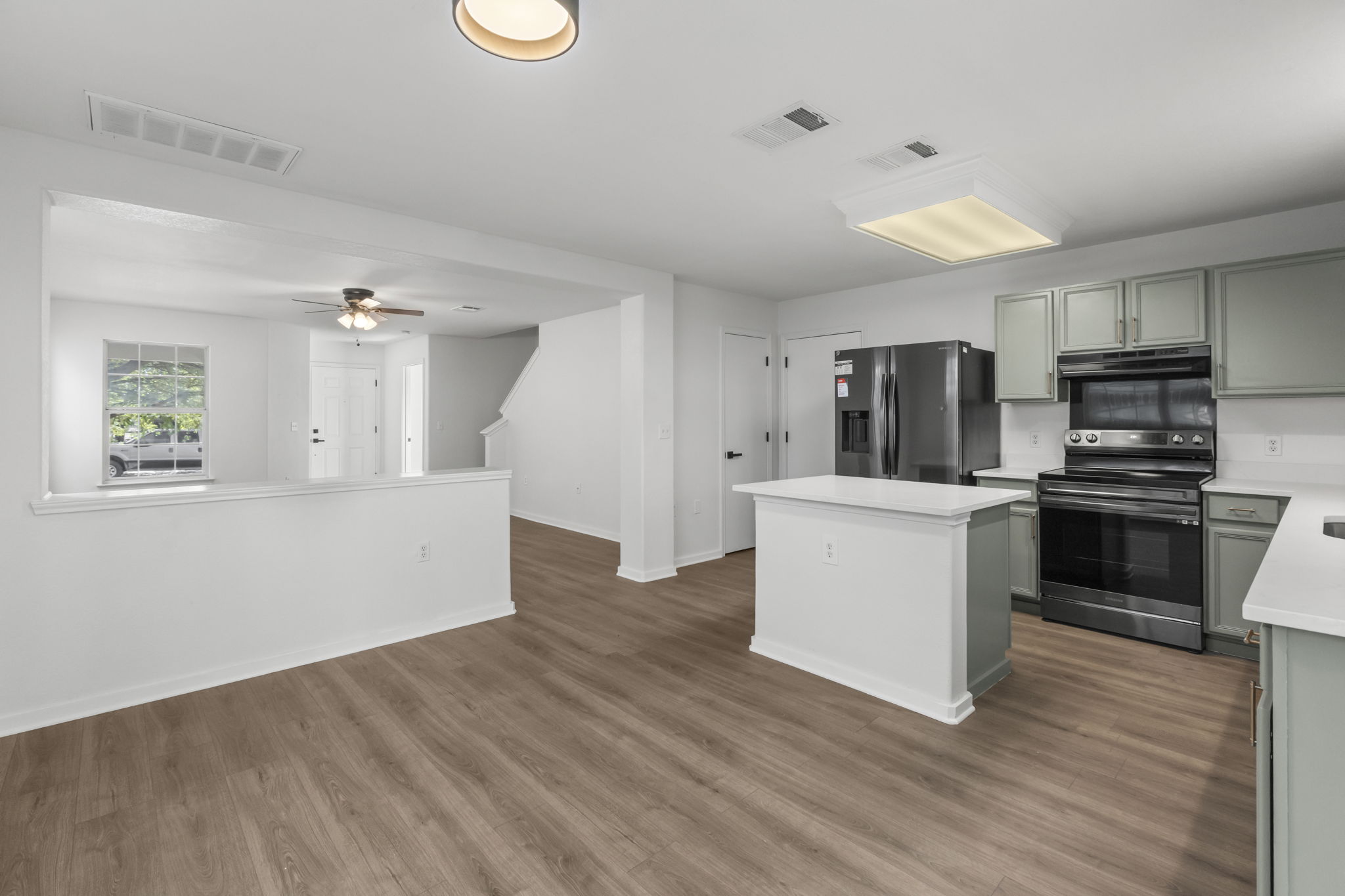 2110 Nogales Trail Austin, TX 78744 - Photo 15 of 37 a kitchen with a refrigerator and a stove top oven