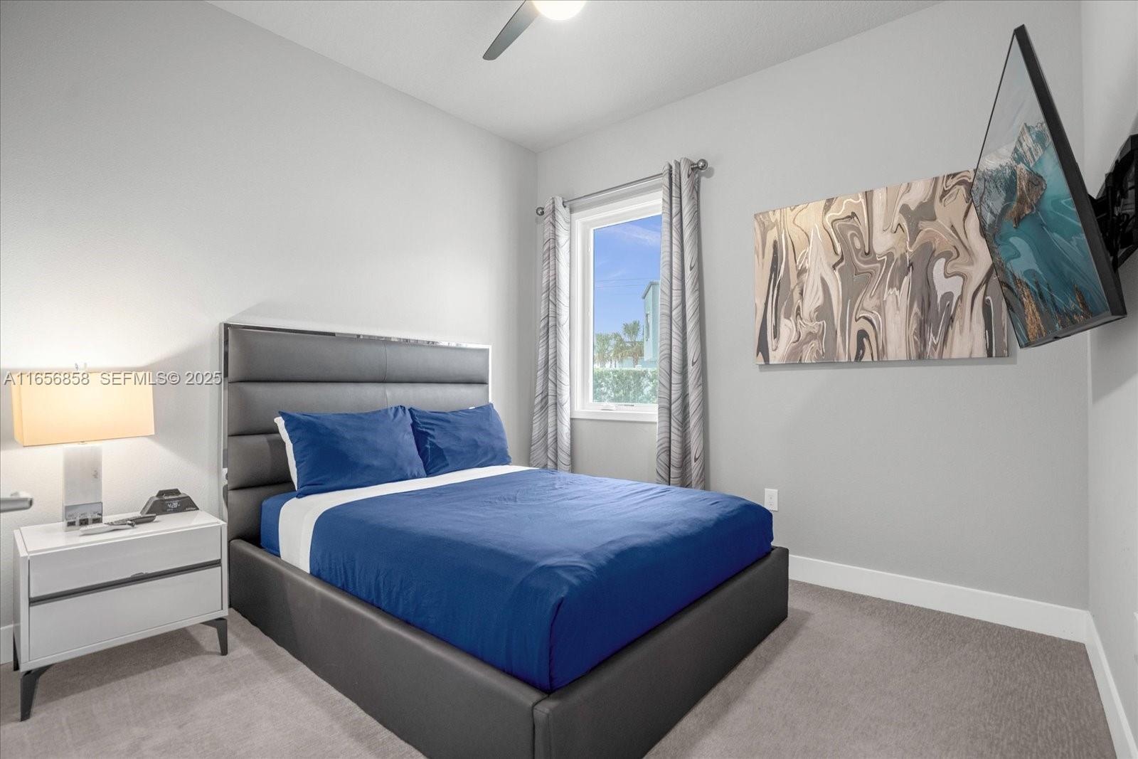 7740 Sandy Ridge Drive, Unit 112 Kissimmee, FL 34747 - Photo 17 of 38 a bedroom with a bed and a painting on the wall