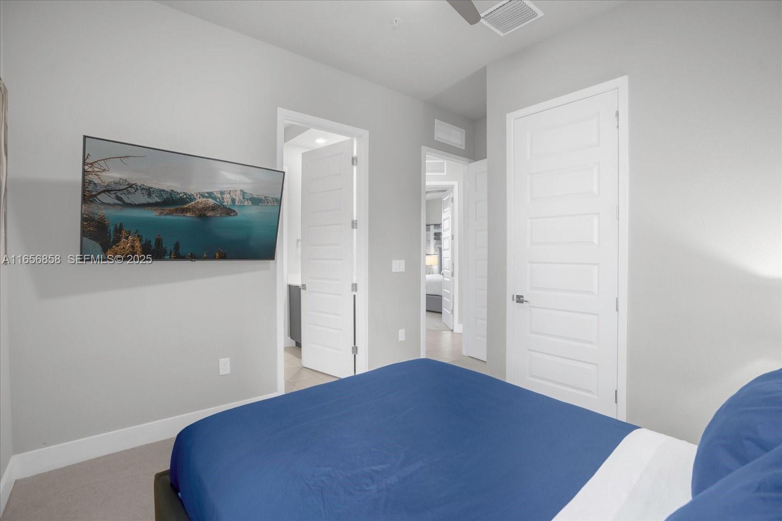 7740 Sandy Ridge Drive, Unit 112 Kissimmee, FL 34747 - Photo 19 of 38 a bedroom with a bed and a flat screen tv