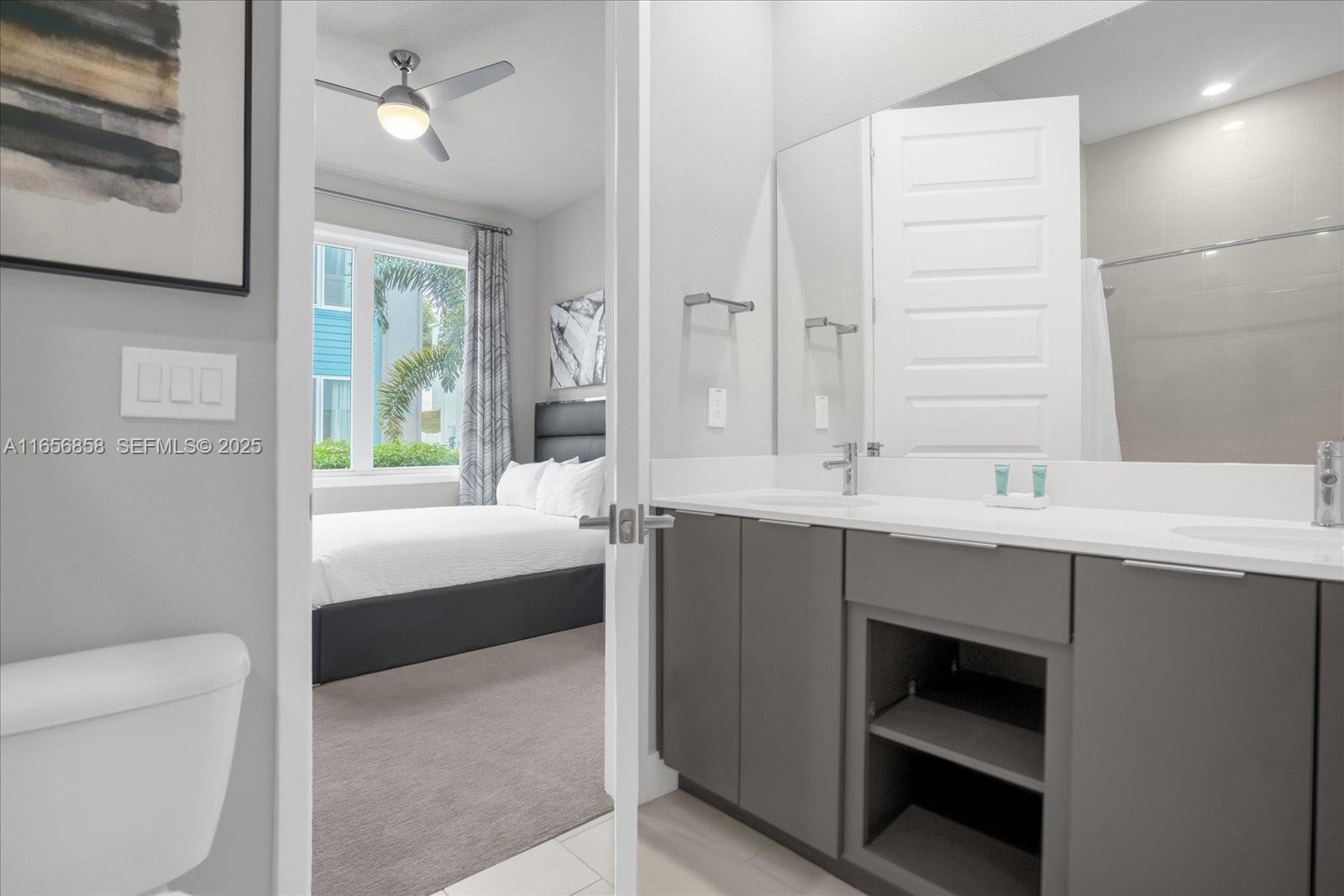 7740 Sandy Ridge Drive, Unit 112 Kissimmee, FL 34747 - Photo 24 of 38 a bathroom with a sink a toilet and a mirror