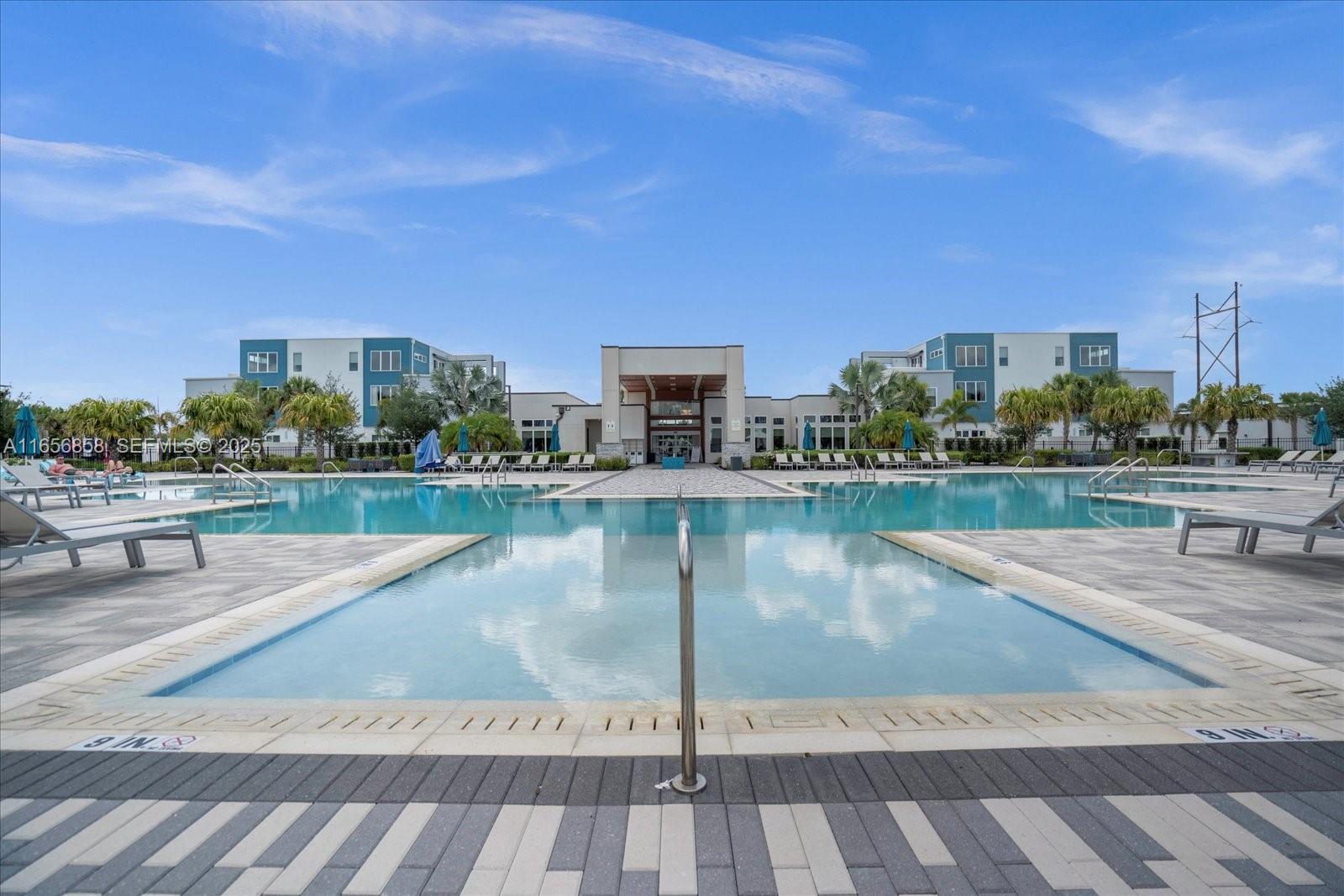 7740 Sandy Ridge Drive, Unit 112 Kissimmee, FL 34747 - Photo 29 of 38 a lake view with a bench and large trees