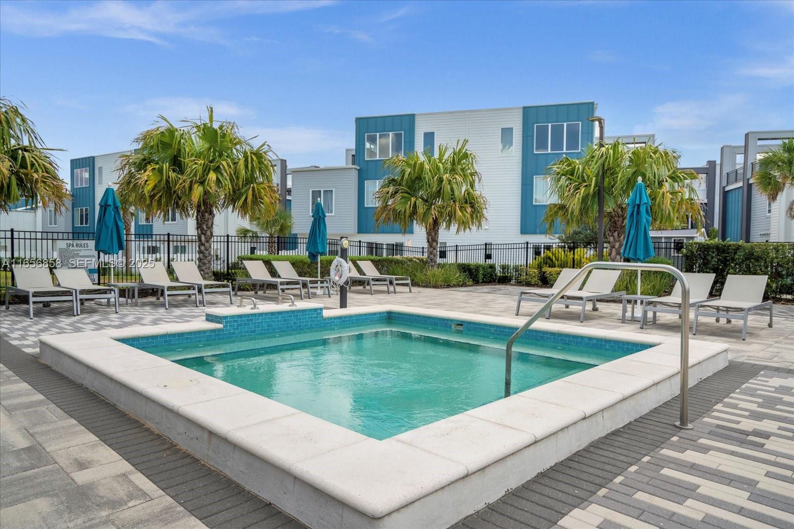 7740 Sandy Ridge Drive, Unit 112 Kissimmee, FL 34747 - Photo 31 of 38 a view of swimming pool with outdoor seating and house in the background
