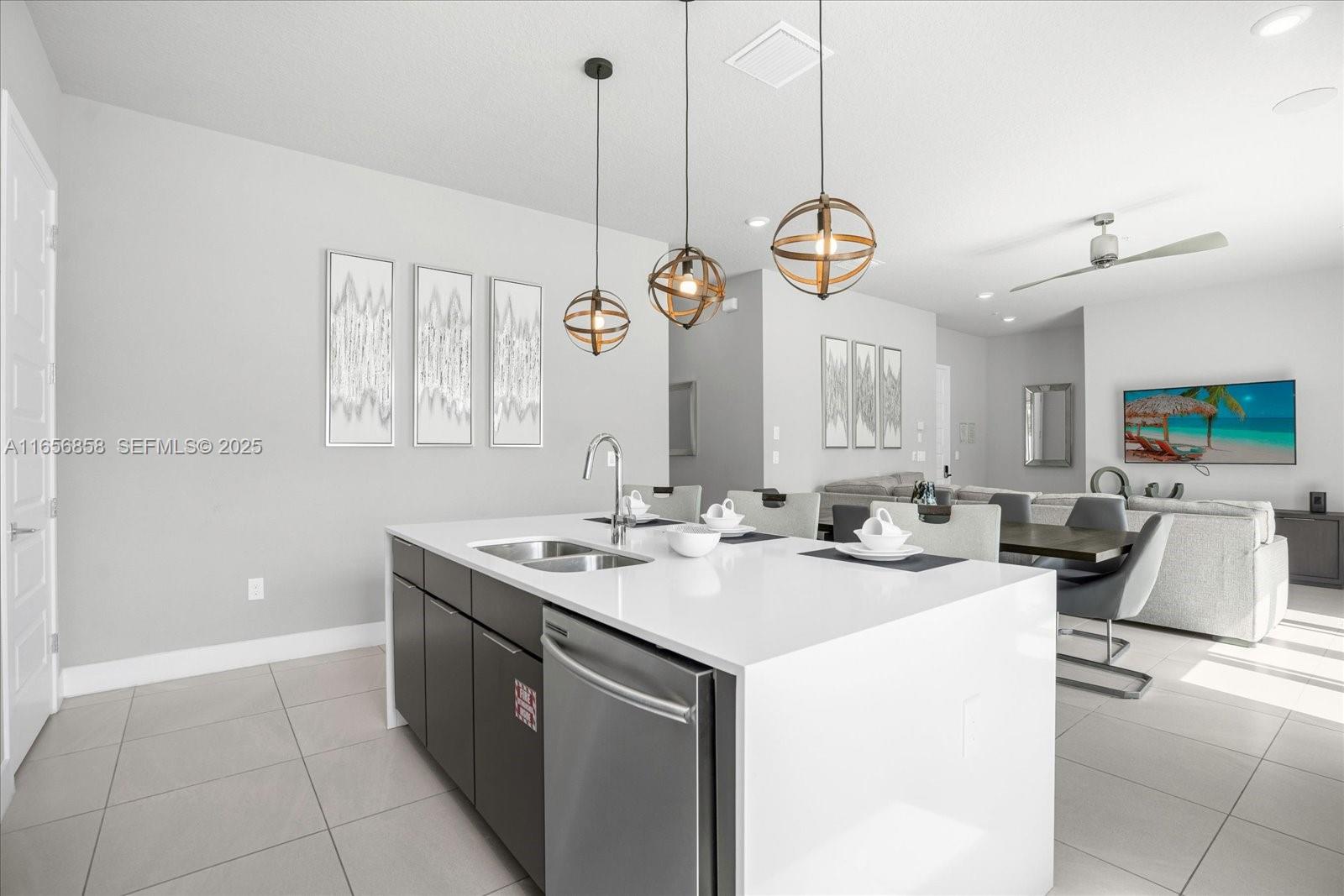 7740 Sandy Ridge Drive, Unit 112 Kissimmee, FL 34747 - Photo 4 of 38 a kitchen with a sink a stove and a wooden floors