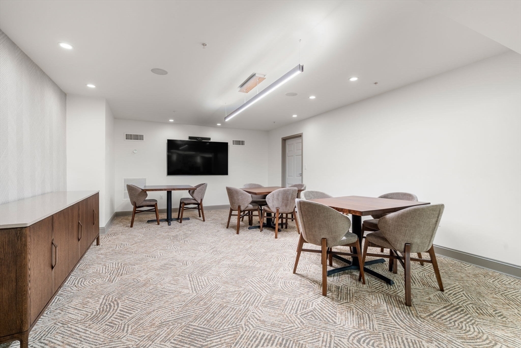 20 Chapel Street, Unit B801 Brookline, MA 02446 - Photo 19 of 27 a view of a dining room with furniture
