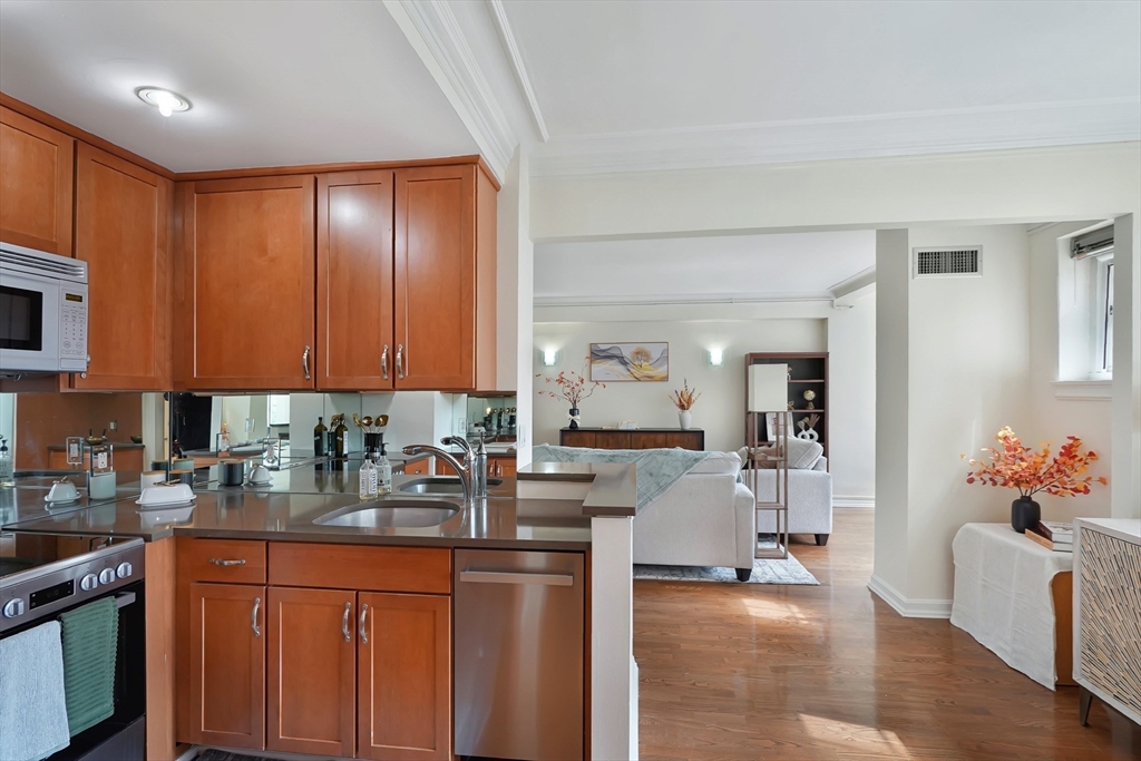 20 Chapel Street, Unit B801 Brookline, MA 02446 - Photo 2 of 27 a kitchen with granite countertop a sink dishwasher stove and cabinets