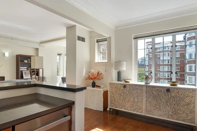 a living room with furniture and large windows