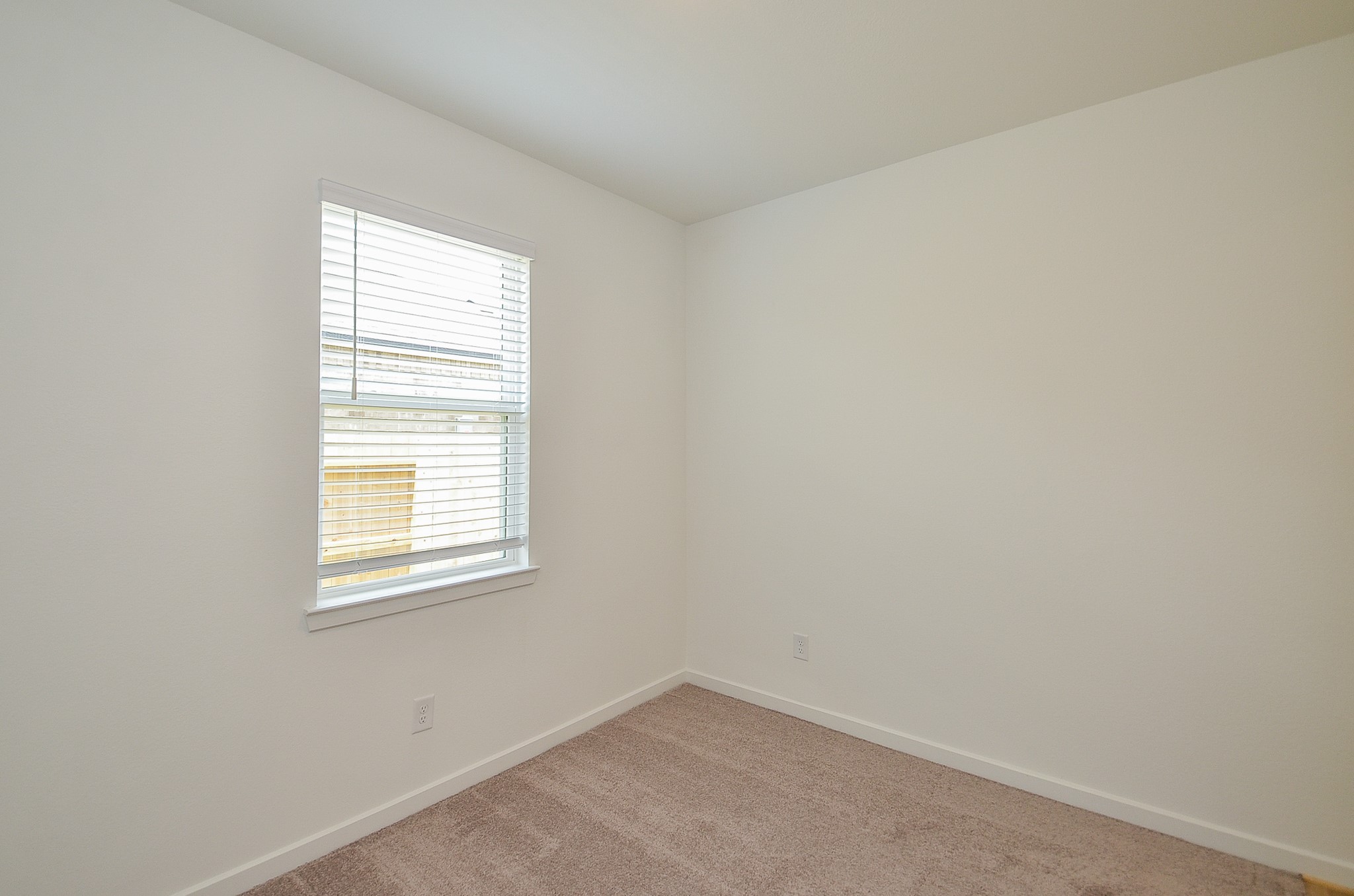 9727 Rialto Hts Drive Cypress, TX 77433 - Photo 31 of 37 This is a spacious walk-in closet with white walls, carpeted flooring, and multiple wooden hanging rods for ample storage.