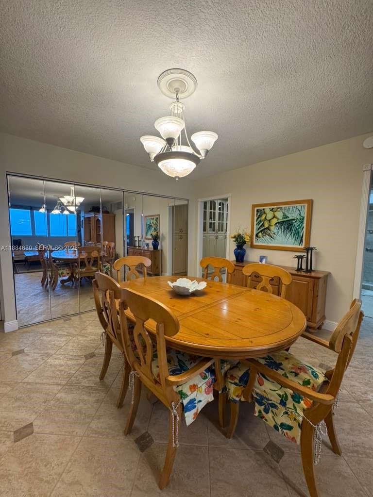 5005 Collins Avenue, Unit 714 Miami Beach, FL 33140 - Photo 12 of 36 a dining room with furniture and window