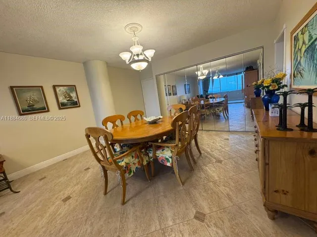 a view of a dining room with furniture and chandelier
