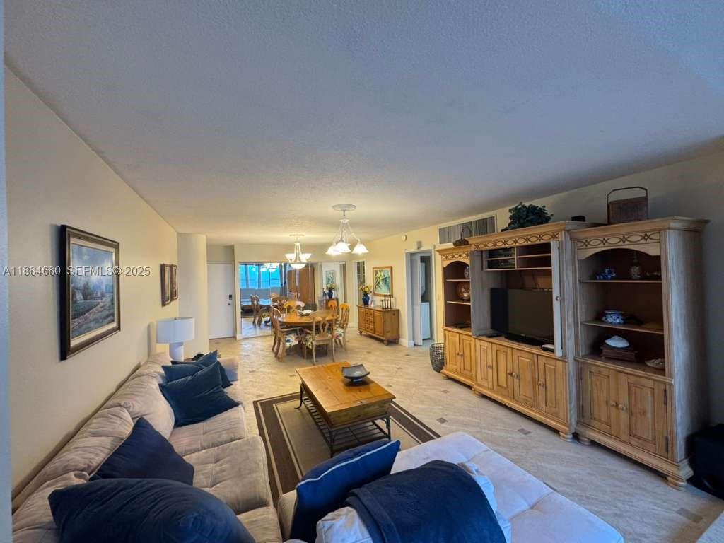 5005 Collins Avenue, Unit 714 Miami Beach, FL 33140 - Photo 16 of 36 a living room with furniture and a flat screen tv