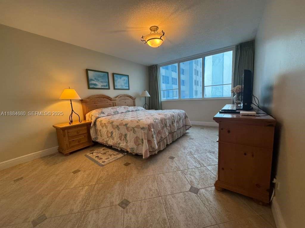 5005 Collins Avenue, Unit 714 Miami Beach, FL 33140 - Photo 22 of 36 a bedroom with a bed and window
