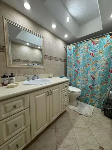 a spacious bathroom with a double vanity sink mirror and toilet