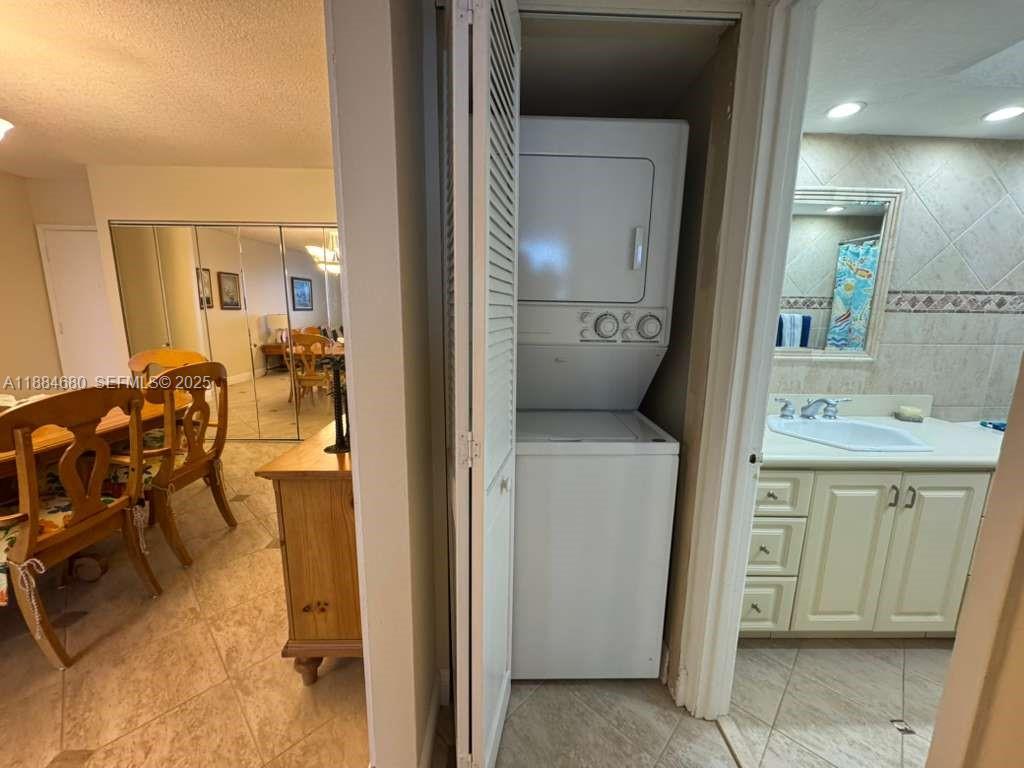 5005 Collins Avenue, Unit 714 Miami Beach, FL 33140 - Photo 24 of 36 a en suite bathroom with a toilet sink and mirror