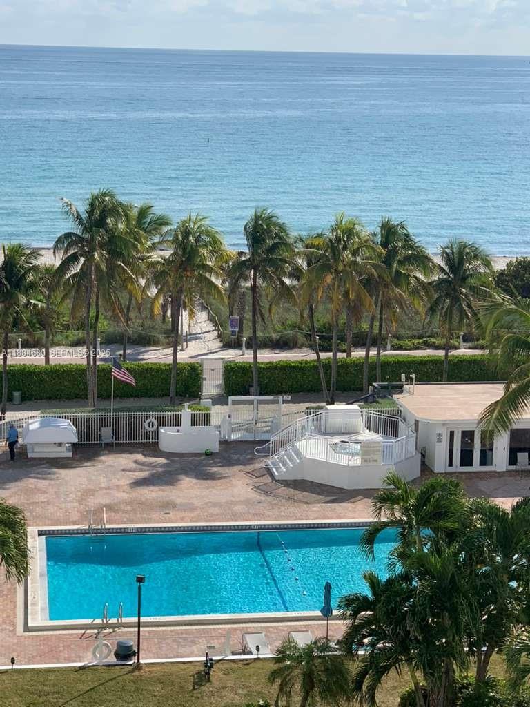 5005 Collins Avenue, Unit 714 Miami Beach, FL 33140 - Photo 32 of 36 a view of a swimming pool with an outdoor space and seating area