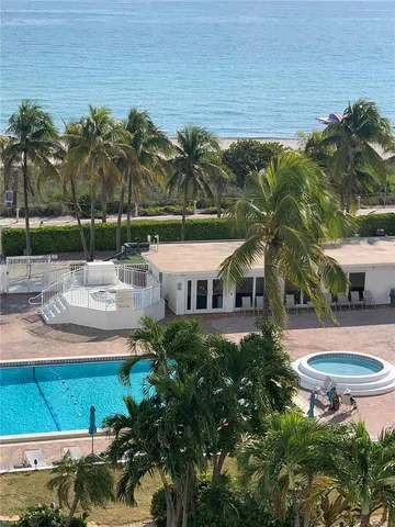 a swimming pool with outdoor seating and yard
