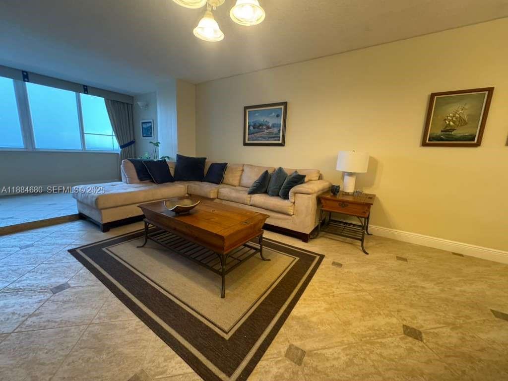 5005 Collins Avenue, Unit 714 Miami Beach, FL 33140 - Photo 9 of 36 a living room with furniture and a rug