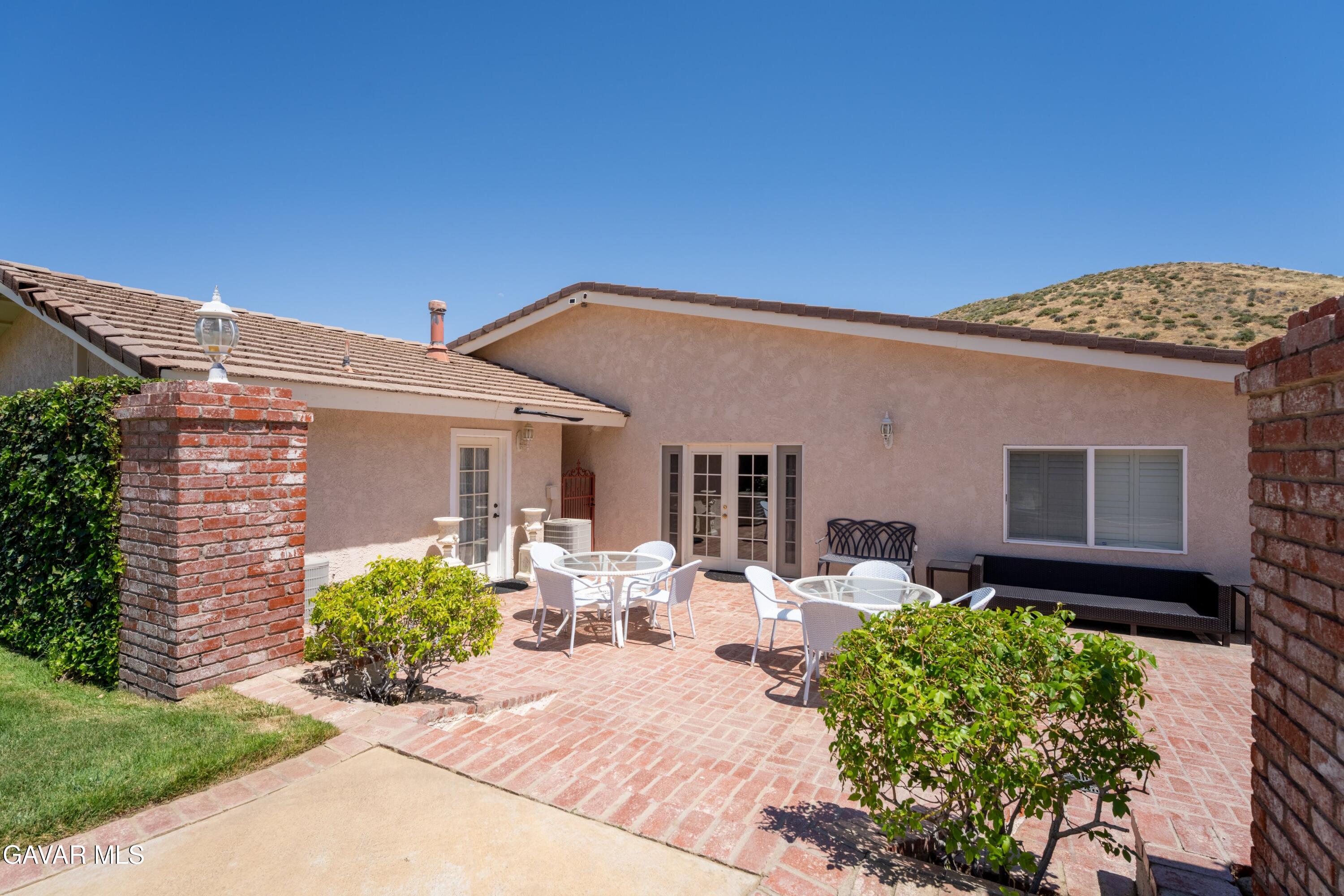5801 Hacienda Ranch Road Palmdale, CA 93551 - Photo 58 of 69 a front view of a house with a yard