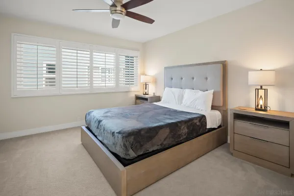 a spacious bedroom with a bed and window