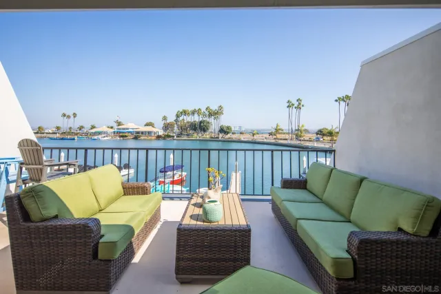 a roof deck with couches and potted plants