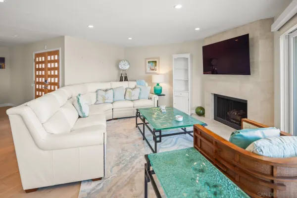 a living room with fireplace furniture and a flat screen tv