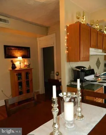 a dining room with furniture and wooden floor