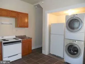 a utility room with sink dryer and washer