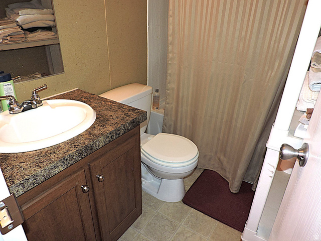 915 North 5000 W Road Hinckley, UT 84635 - Photo 18 of 27 Bathroom vanity featuring a built-in sink and laminate countertop