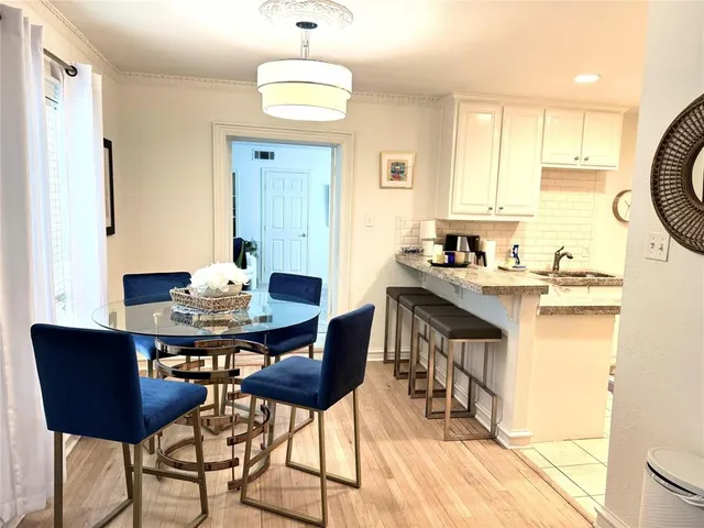 a kitchen with a table chairs stove and cabinets
