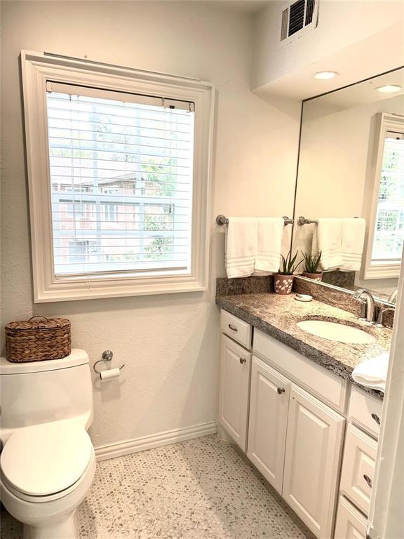 4538 Roland Avenue, Unit 4 Highland Park, TX 75219 - Photo 9 of 9 a bathroom with a granite countertop sink toilet and mirror