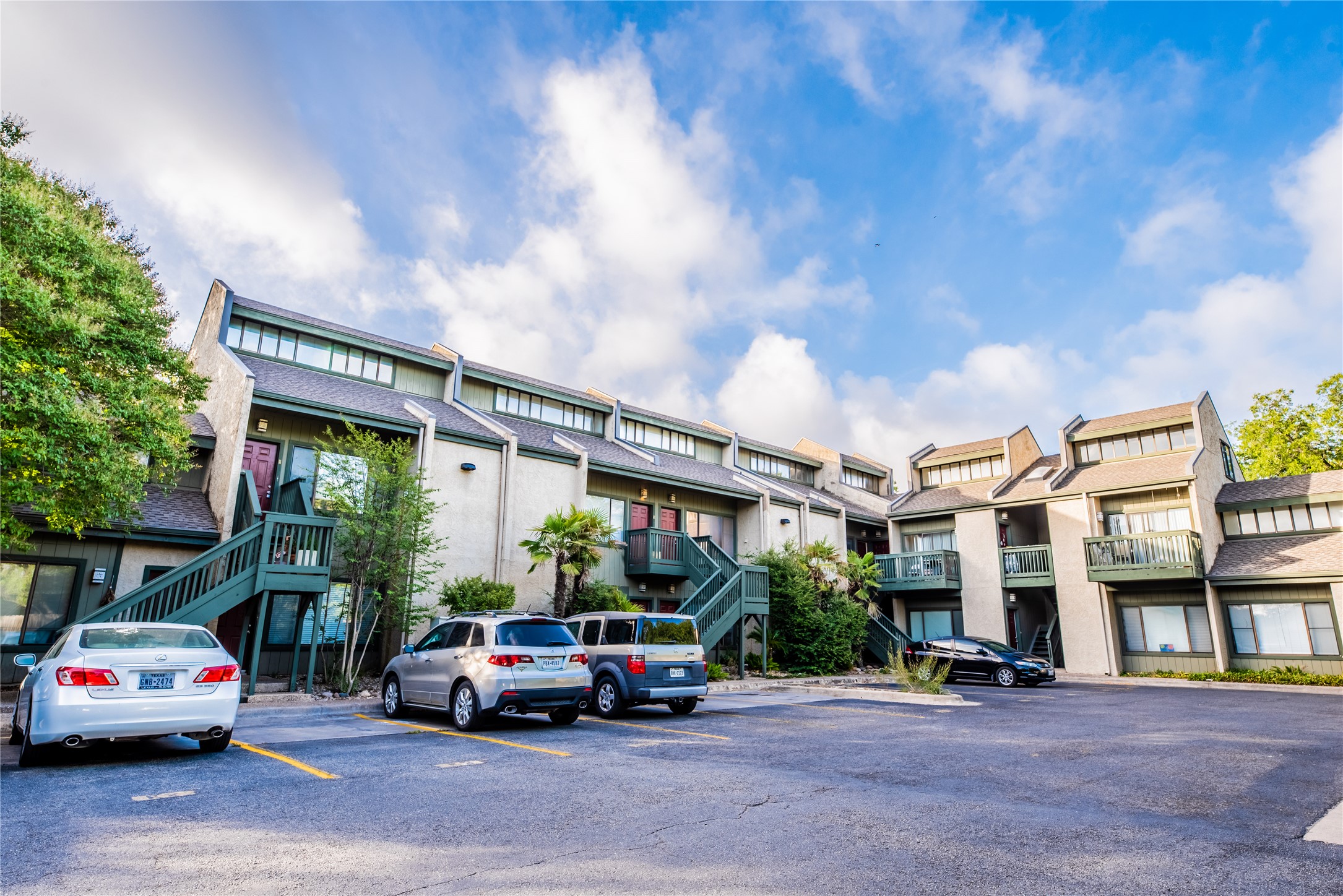 601 Nelray Boulevard, Unit 5 Austin, TX 78751 - Photo 2 of 13 View of building exterior featuring stairs and uncovered parking